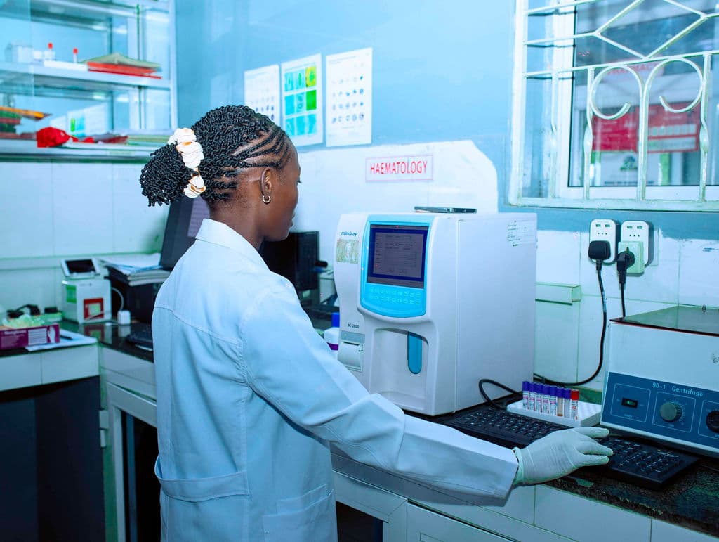 Laboratory technician operating the haematology analyser